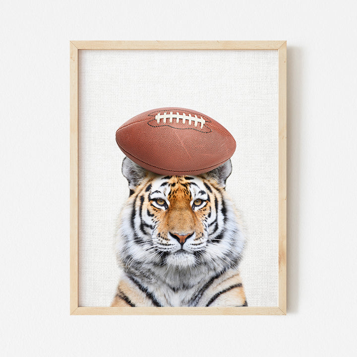 a picture of a tiger with a football on its head