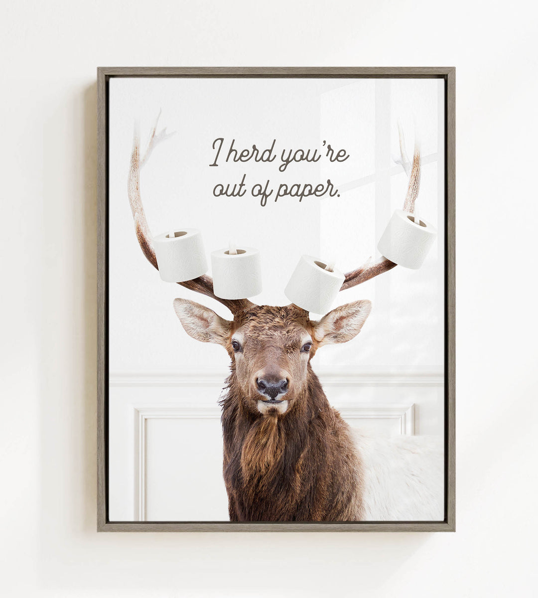 A deer with antlers holding multiple rolls of toilet paper, with the text "I herd you're out of paper" above it.