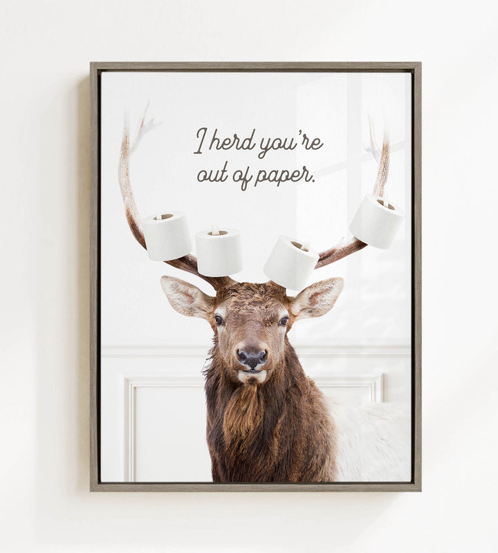 A deer with antlers holding multiple rolls of toilet paper, with the text "I herd you're out of paper" above it.