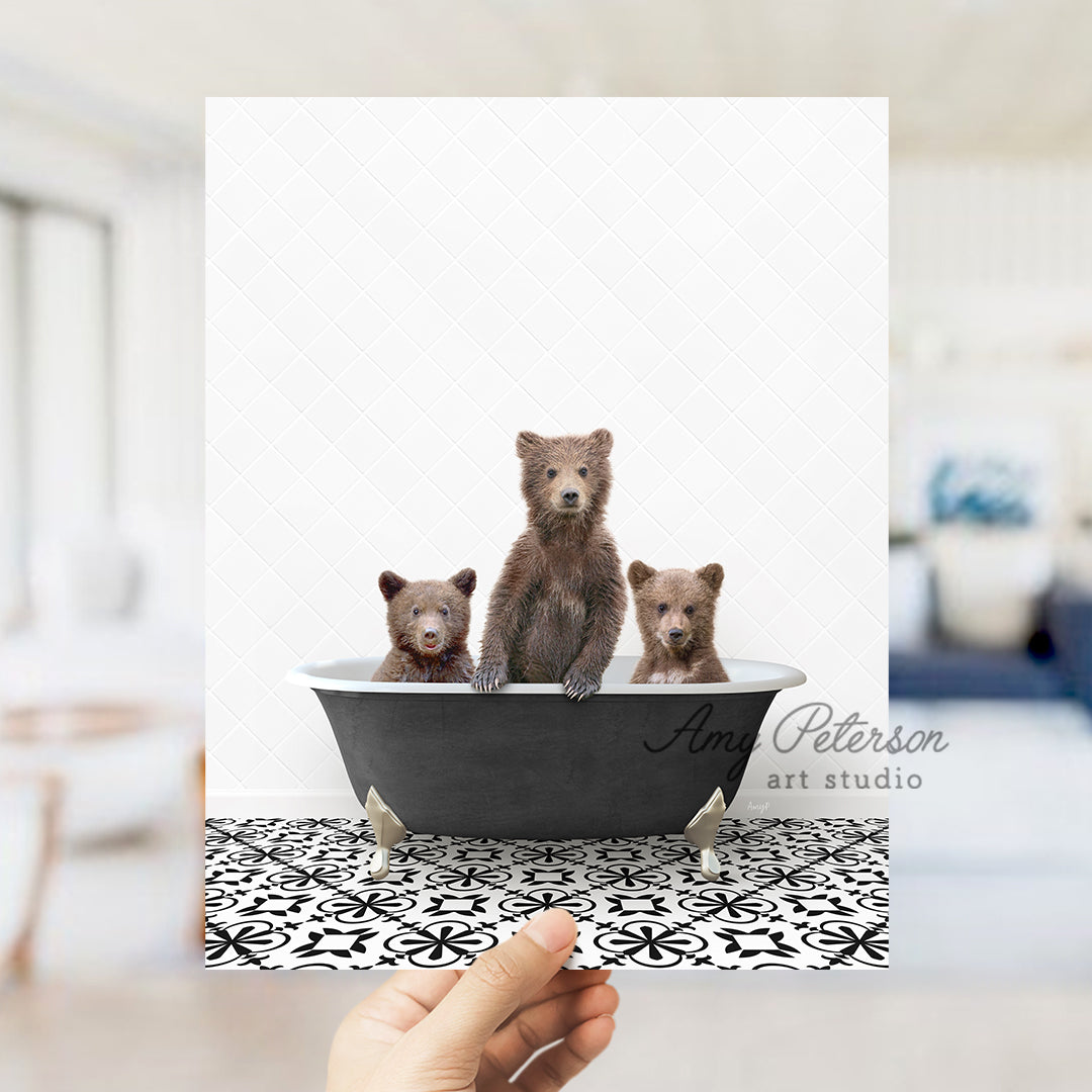 a person holding up a card with three bears in a bathtub