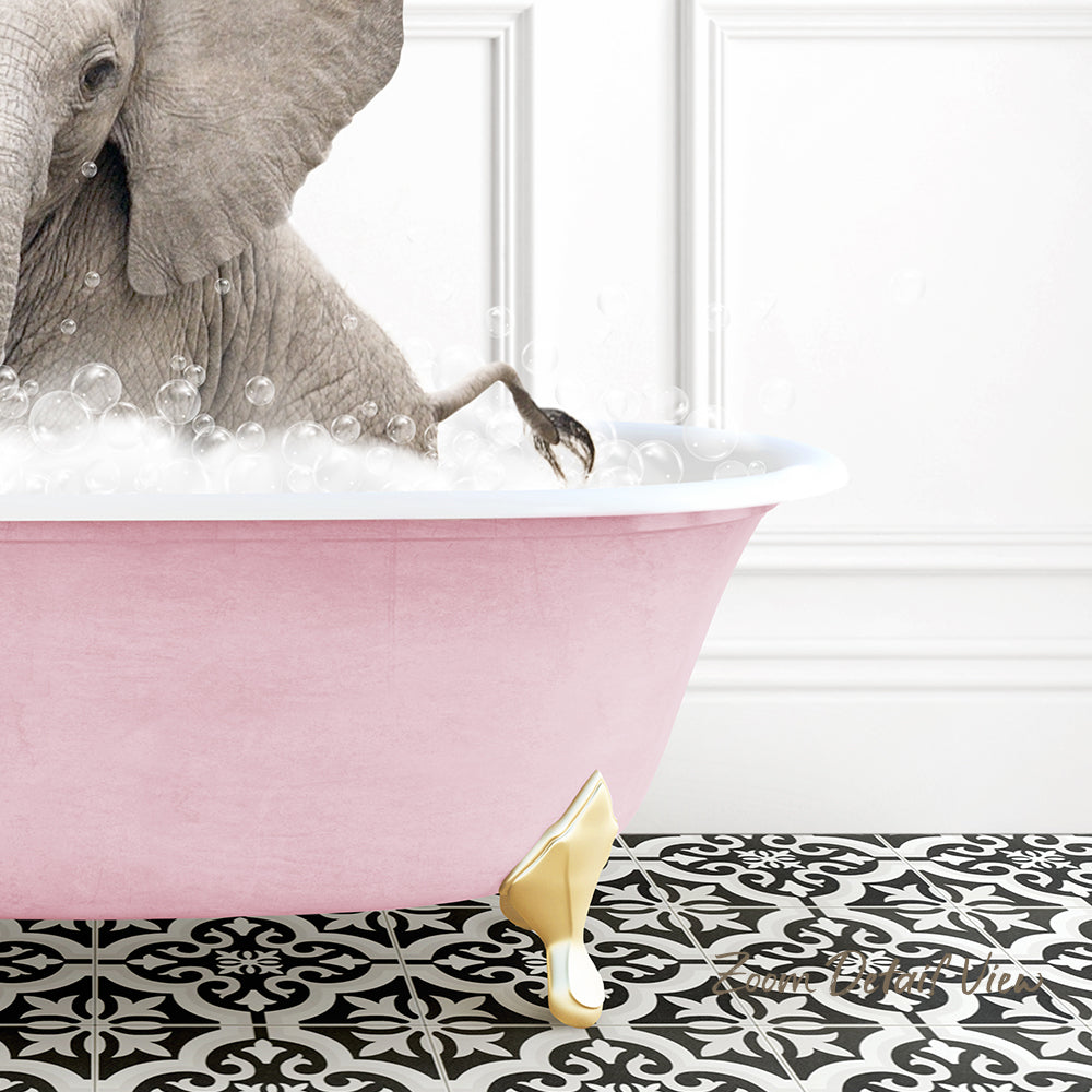 A gray elephant is standing in a pink bathtub filled with bubbles, with its trunk submerged in the water.