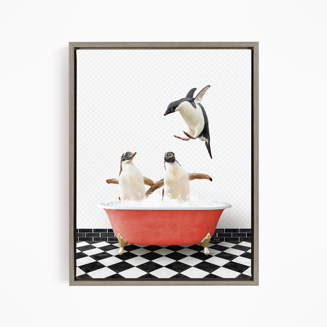 A framed image depicting two penguins standing in a red bathtub filled with water, with one penguin flying towards the other.
