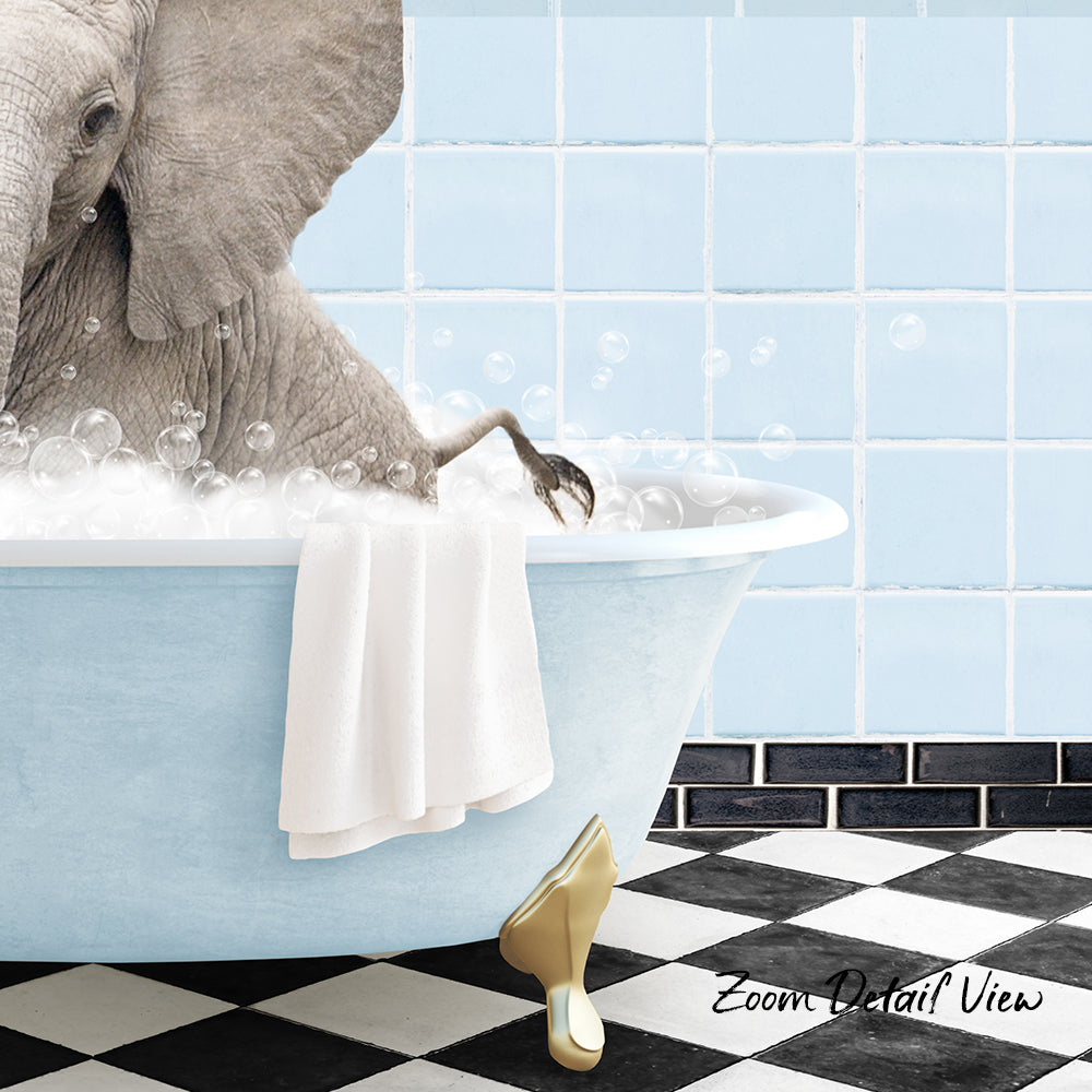 A gray elephant is sitting in a blue bathtub filled with bubbles, with a towel hanging on the side and a yellow shoe placed on the floor.