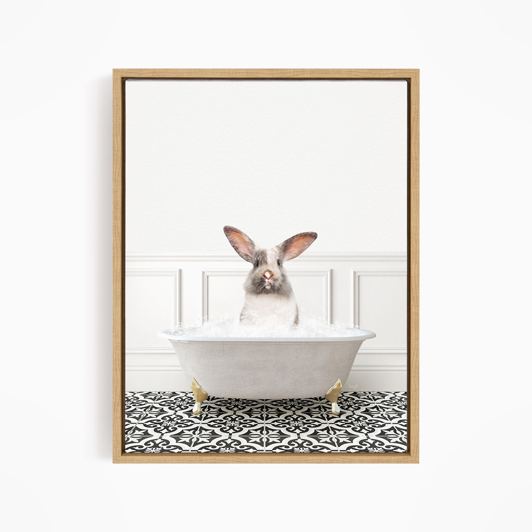 A white rabbit sitting in a white bathtub filled with water, with a black and white patterned floor in the background.