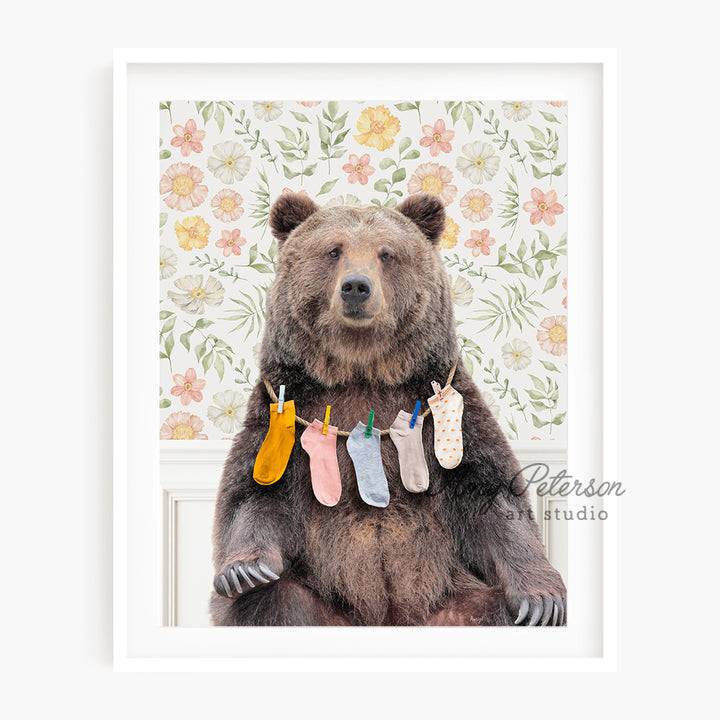 a picture of a brown bear holding baby socks