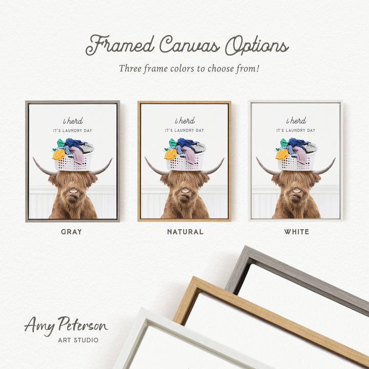 The image is a framed canvas option featuring a brown Highland cow with a basket of laundry on its head, accompanied by text indicating three frame colors to choose from: gray, natural, and white.