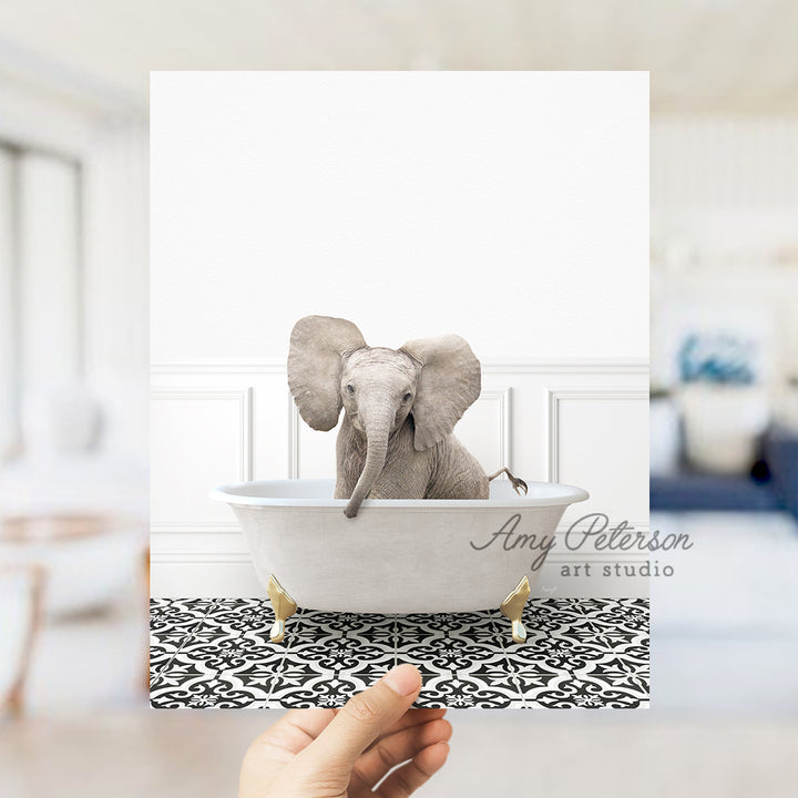 a hand holding a card with an elephant in a bathtub