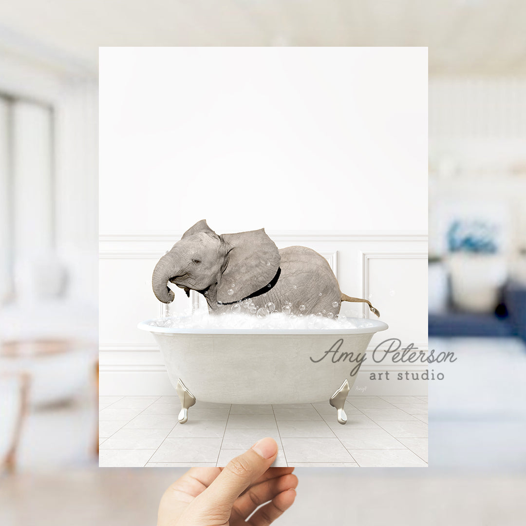 a person holding up a picture of an elephant in a bathtub