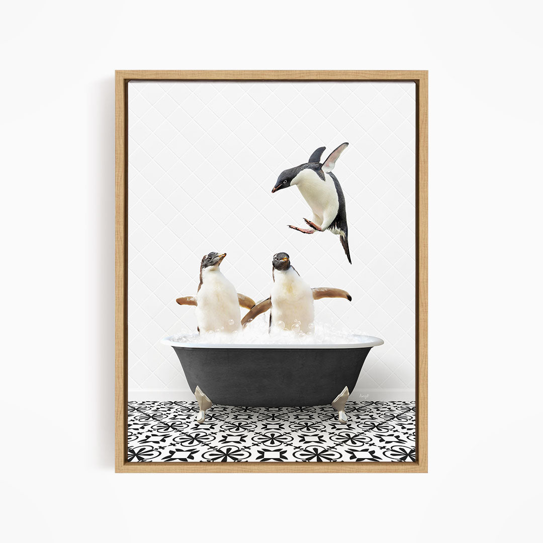 A framed image depicting two penguins standing in a bathtub filled with water, with one penguin flying towards the other.