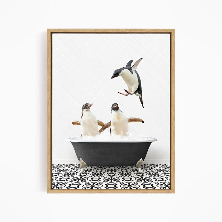 A framed image depicting two penguins standing in a bathtub filled with water, with one penguin flying towards the other.