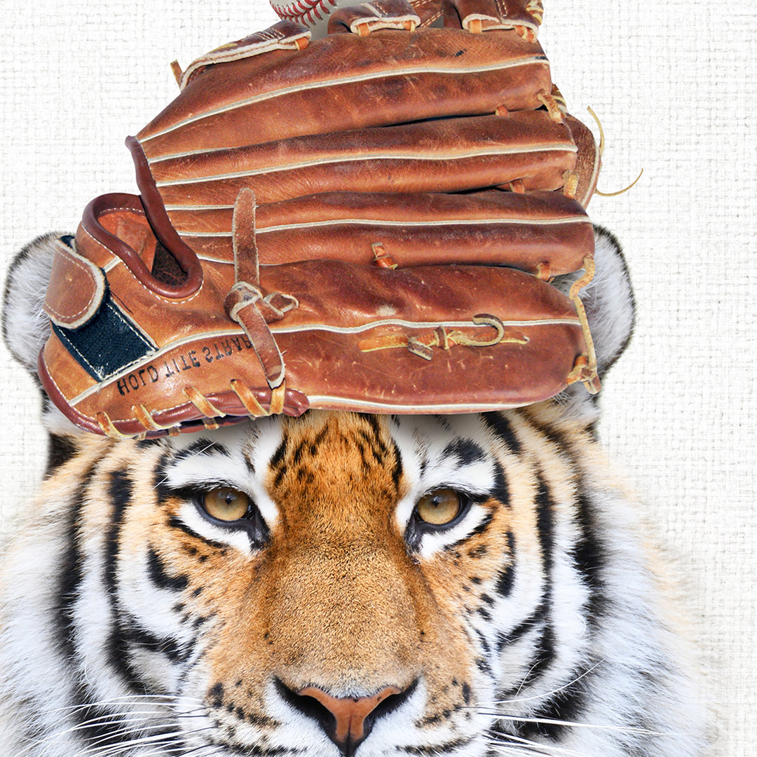 a tiger with a baseball glove on its head