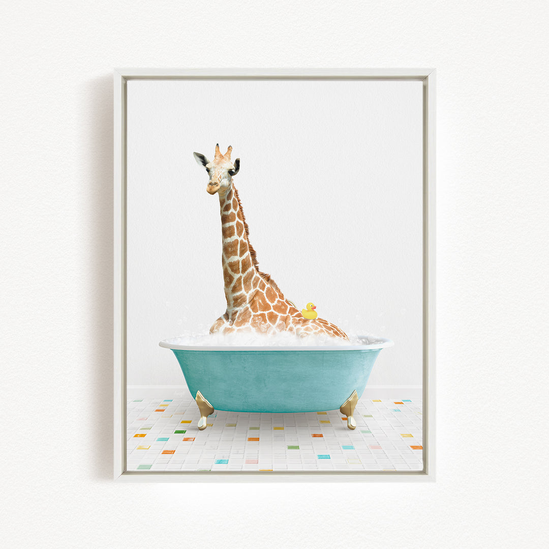A giraffe is sitting in a blue bathtub filled with bubbles, with a yellow duck floating on the water.