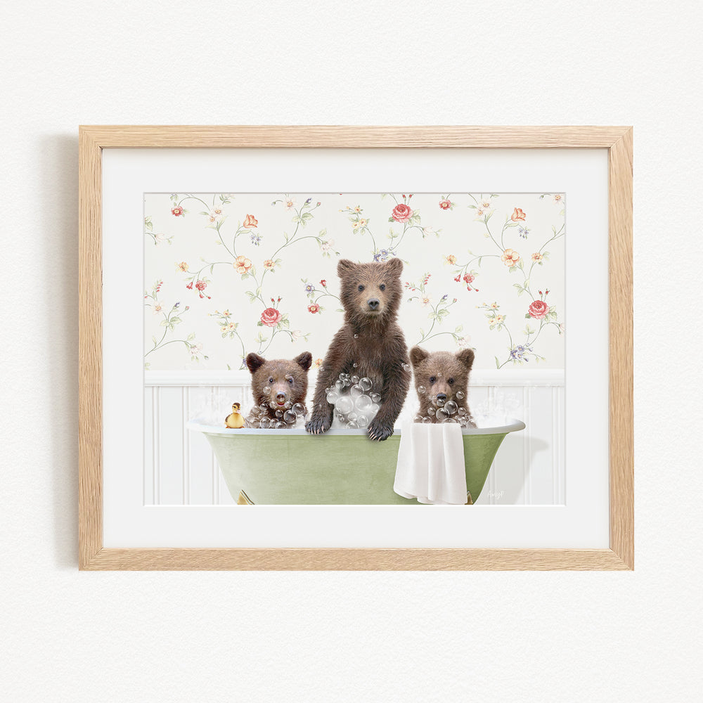 A framed image depicting three bears sitting in a green bathtub filled with bubbles, surrounded by a floral patterned wall.