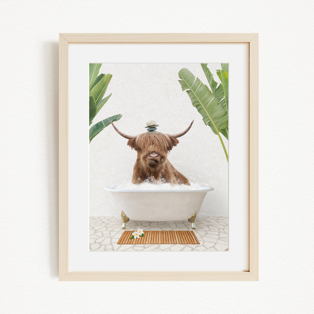 A brown cow with horns is sitting in a white bathtub filled with water, surrounded by green plants and a wooden mat on the floor.