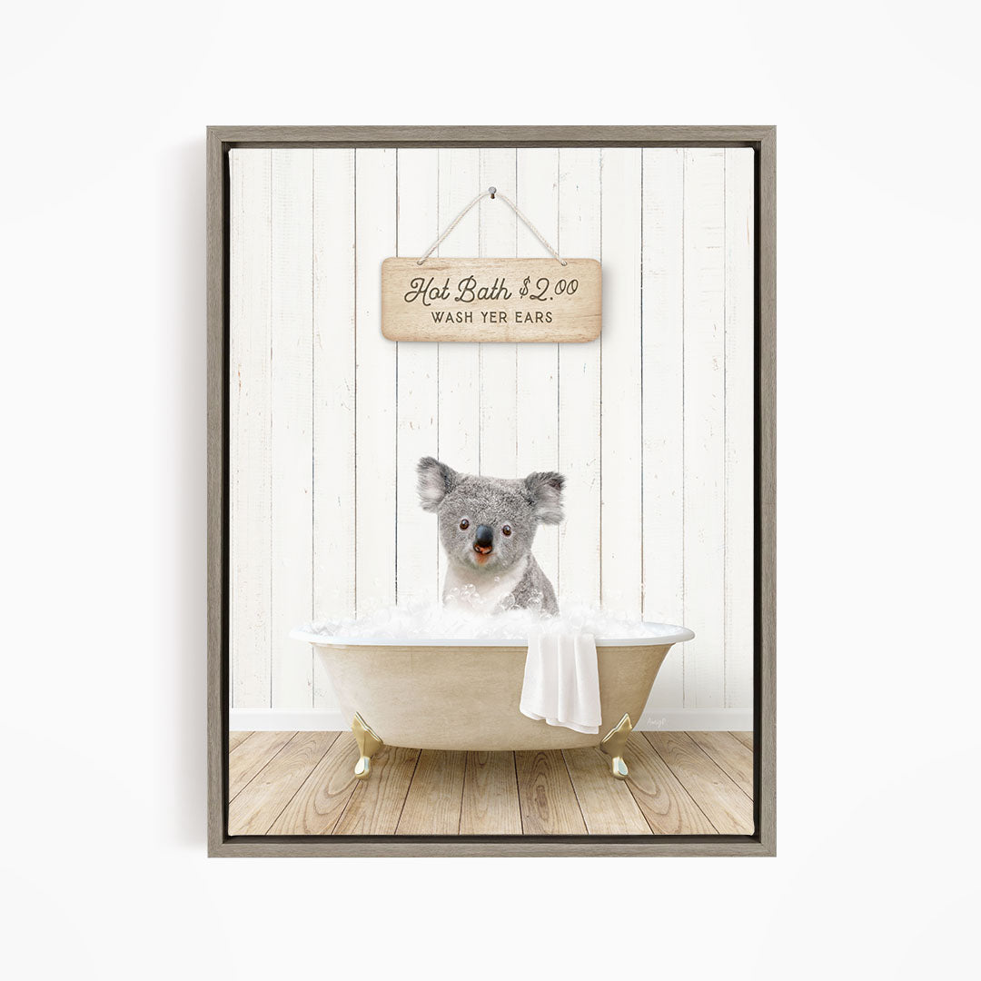 A koala bear sitting in a bathtub, with a sign above it that says "Hot Bath $2.00 WASH YER EARS".