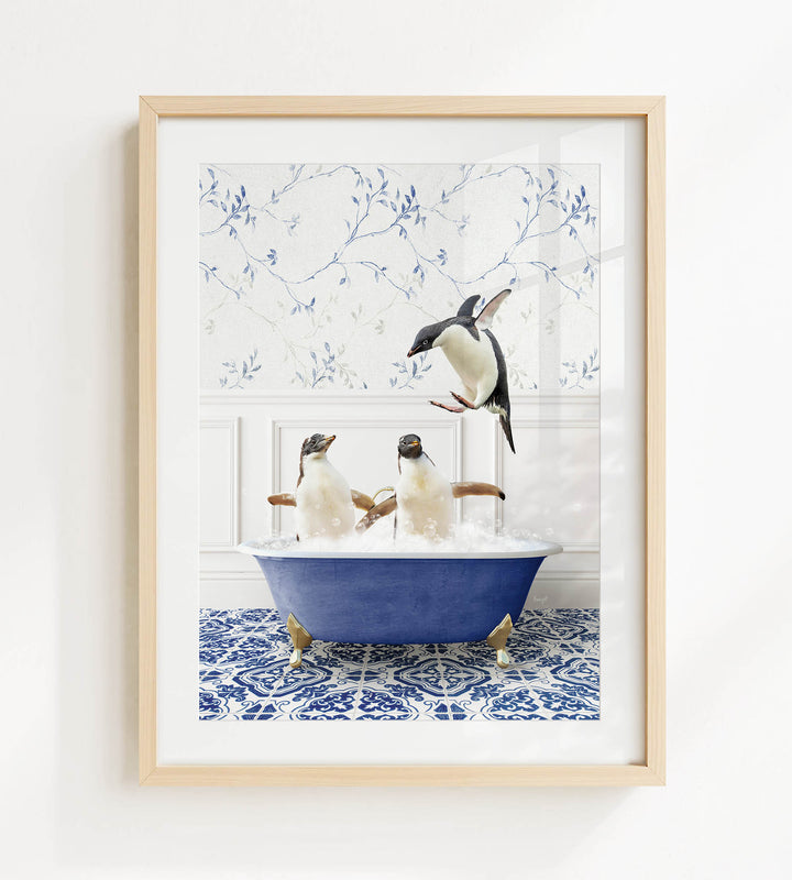 A framed image depicting two penguins sitting in a blue bathtub, with one penguin flying towards the other.