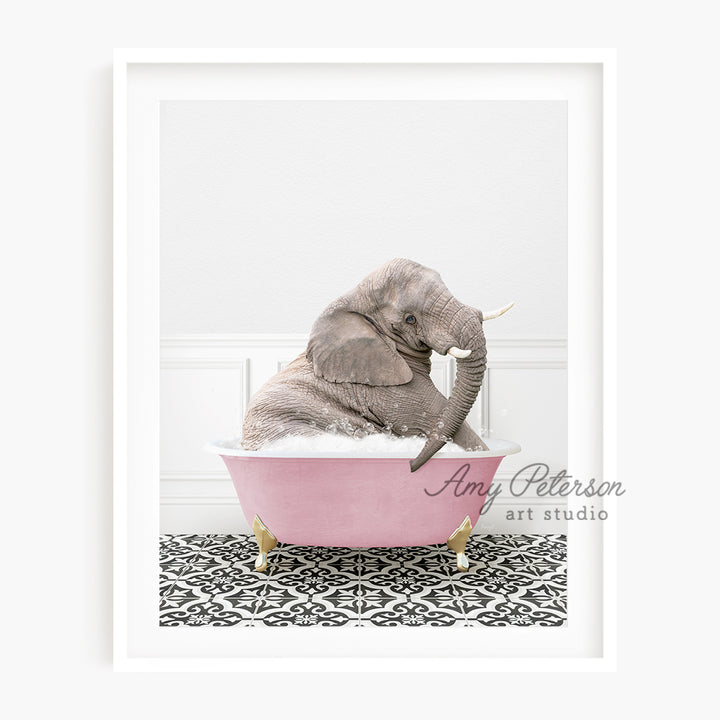 a baby elephant sitting in a pink bath tub