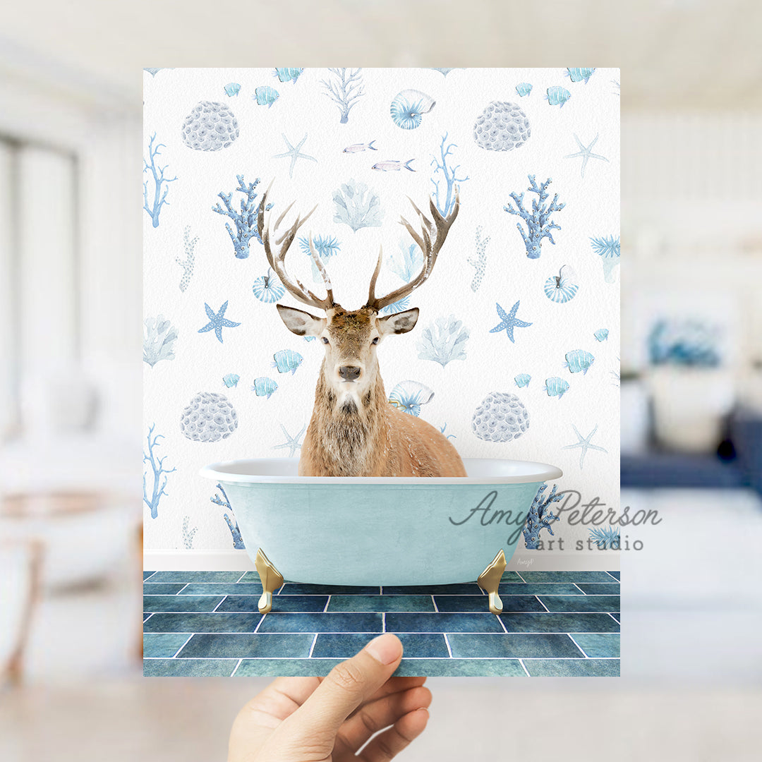 a hand holding up a photo of a deer in a bathtub