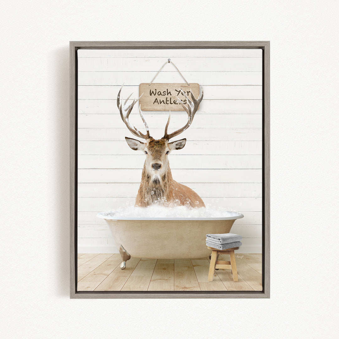 A deer with antlers is sitting in a bathtub filled with water, with a sign above it that says "Wash your antlers".