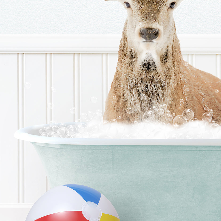 a deer in a bathtub with bubbles and a beach ball