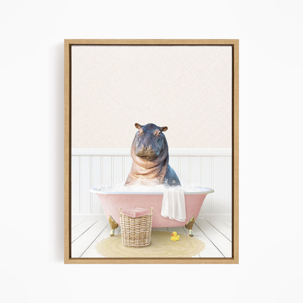 A hippopotamus sitting in a pink bathtub filled with water, surrounded by a basket of toys and a yellow rubber ducky.