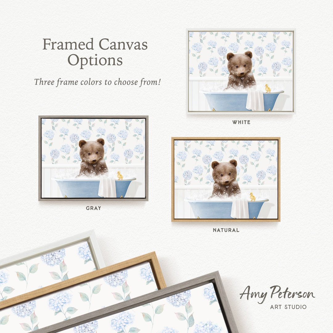 The image is a framed canvas with three different options for the color of the frame: white, gray, and natural. The canvas features a brown bear sitting in a bathtub, surrounded by blue flowers.