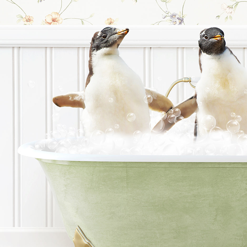 two penguins sitting in a bathtub full of bubbles