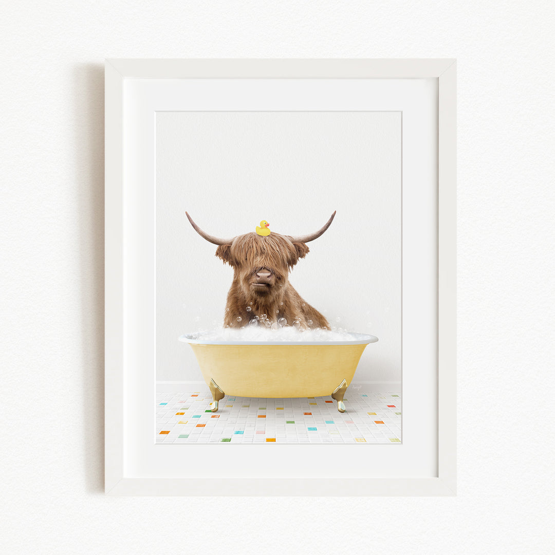 A brown cow with long horns is sitting in a yellow bathtub filled with bubbles, with a rubber duck perched on its head.