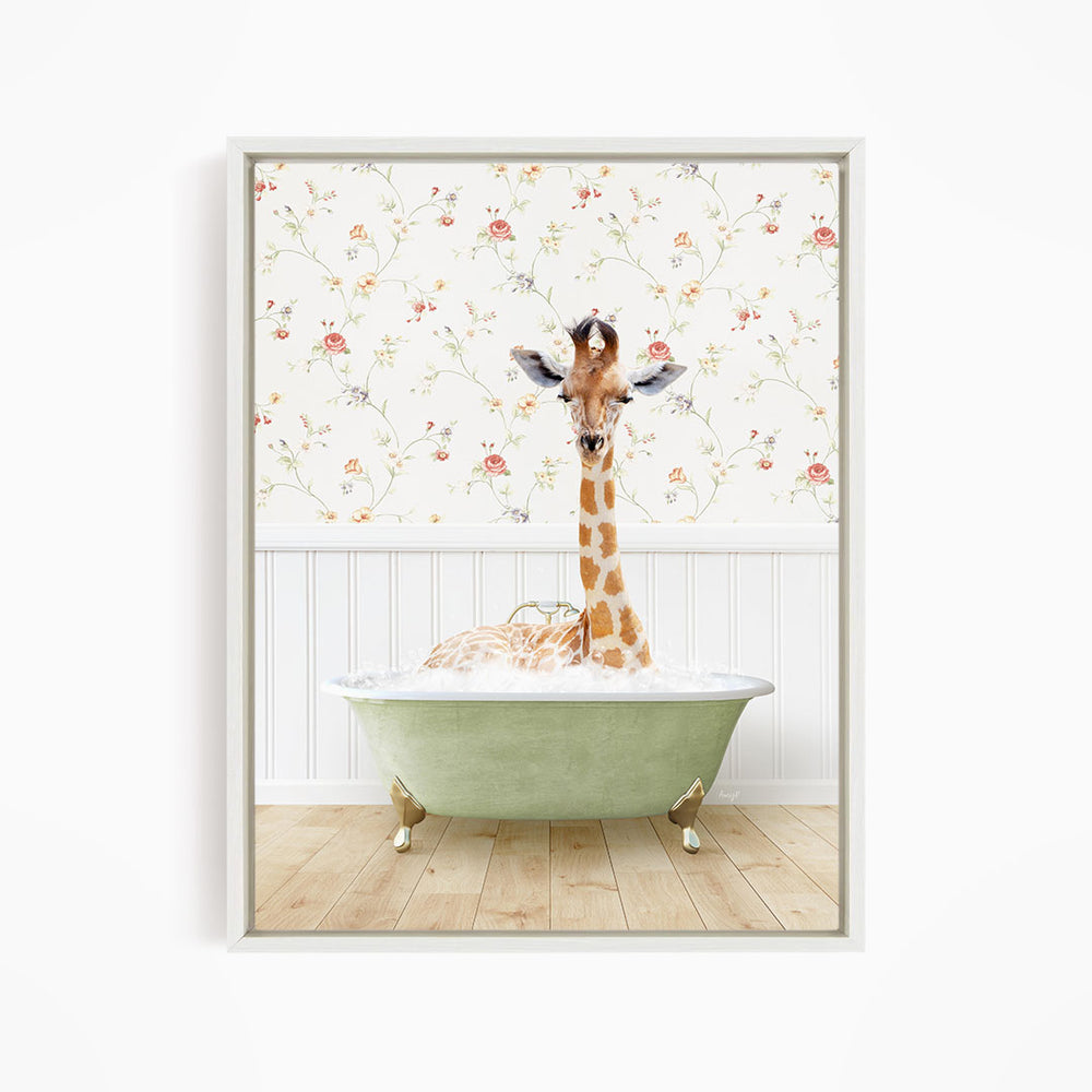A giraffe is sitting in a green bathtub, surrounded by a floral wallpaper.