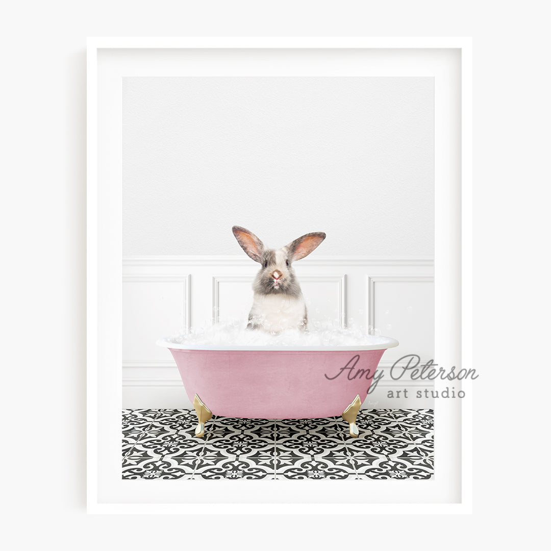 a rabbit sitting in a pink bath tub