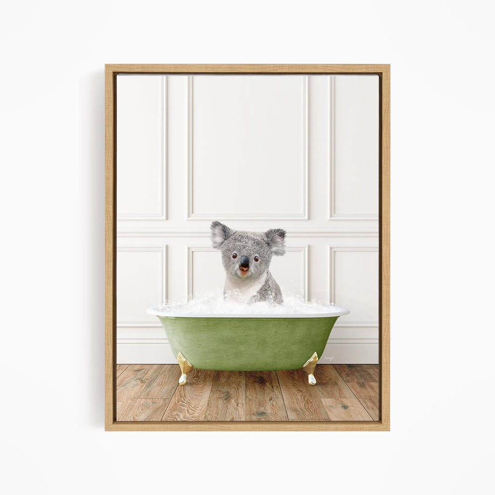 A koala bear sitting in a green bathtub filled with water, looking directly at the camera.