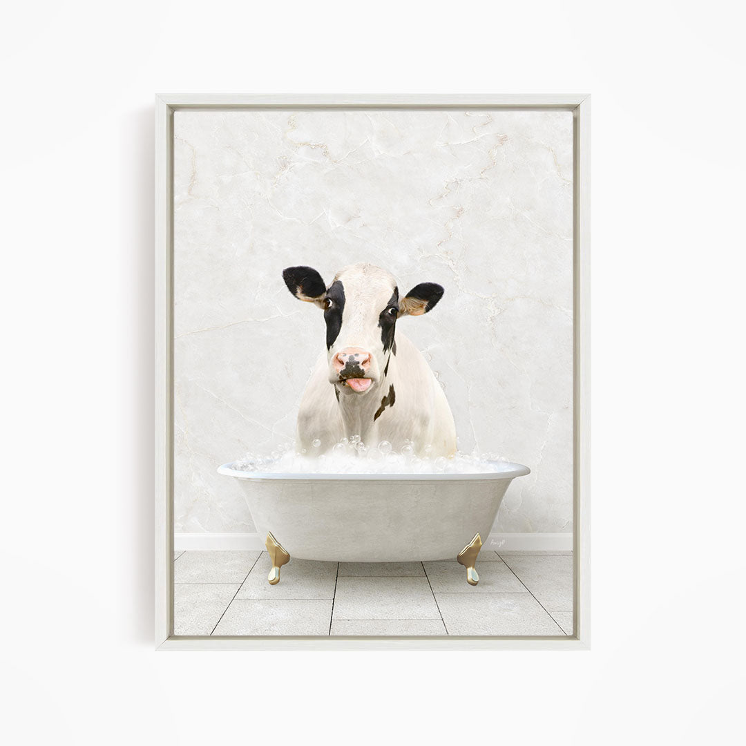 A black and white cow is sitting in a white bathtub filled with water, creating a whimsical and humorous scene.