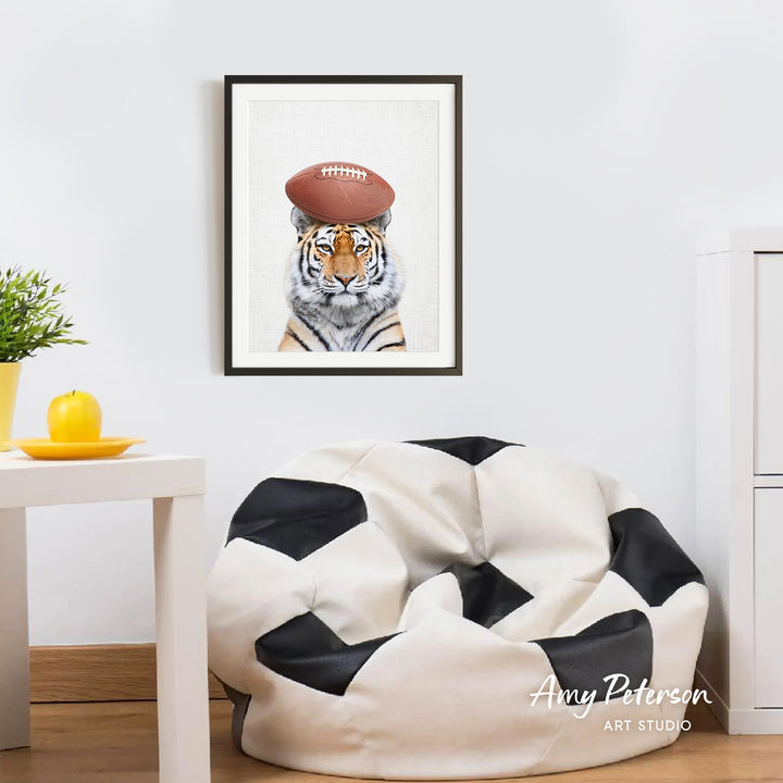 a tiger wearing a football helmet, which is a humorous and playful depiction of the animal participating in a sport.
