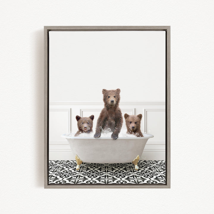 A framed image showing three bears sitting in a white bathtub, with one bear sitting in the center and the other two bears sitting on either side.