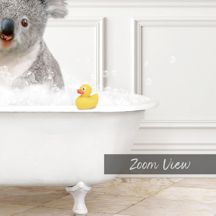 A koala bear sitting in a bathtub filled with bubbles, with a rubber duck floating nearby.