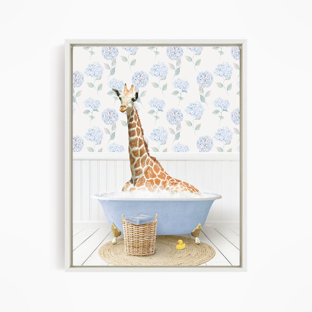 A giraffe is sitting in a blue bathtub filled with water, surrounded by a wicker basket and a yellow rubber duck.