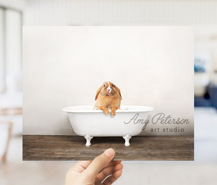 a person holding up a card with a dog in a bathtub