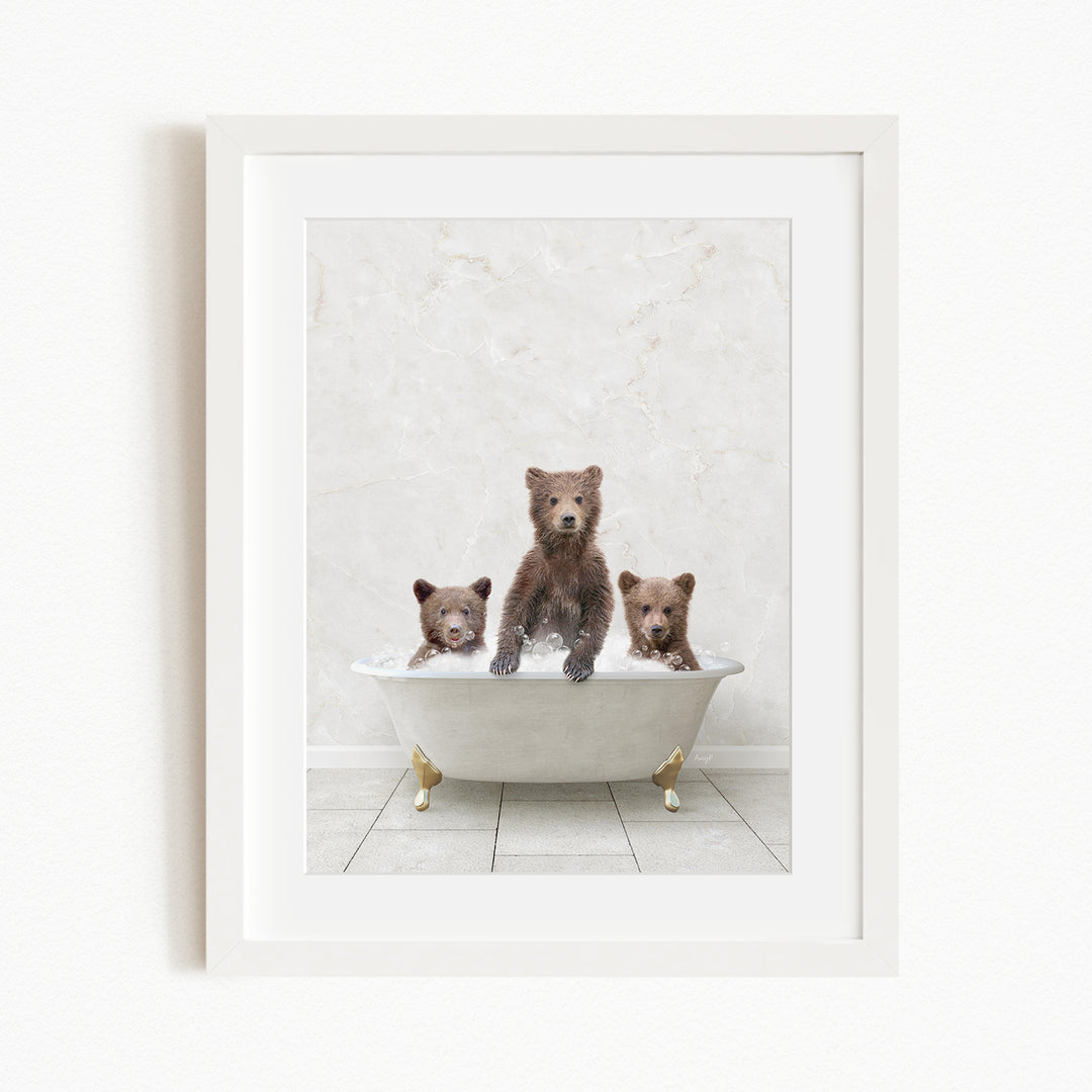 A framed image depicting three brown bears sitting in a white bathtub, with one bear sitting in the center and the other two bears sitting on either side.