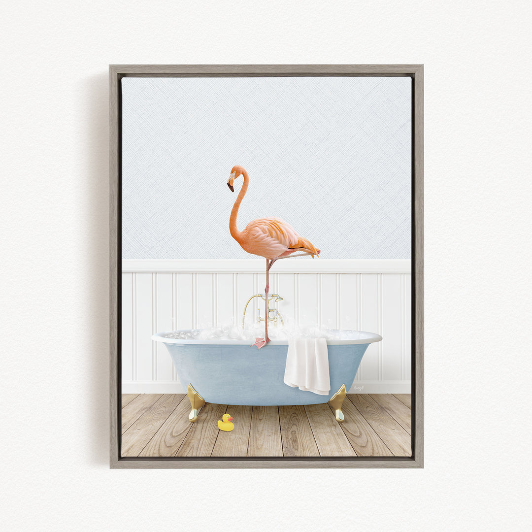 A pink flamingo stands on a blue bathtub, with a white towel and rubber duck nearby, in a bathroom setting.