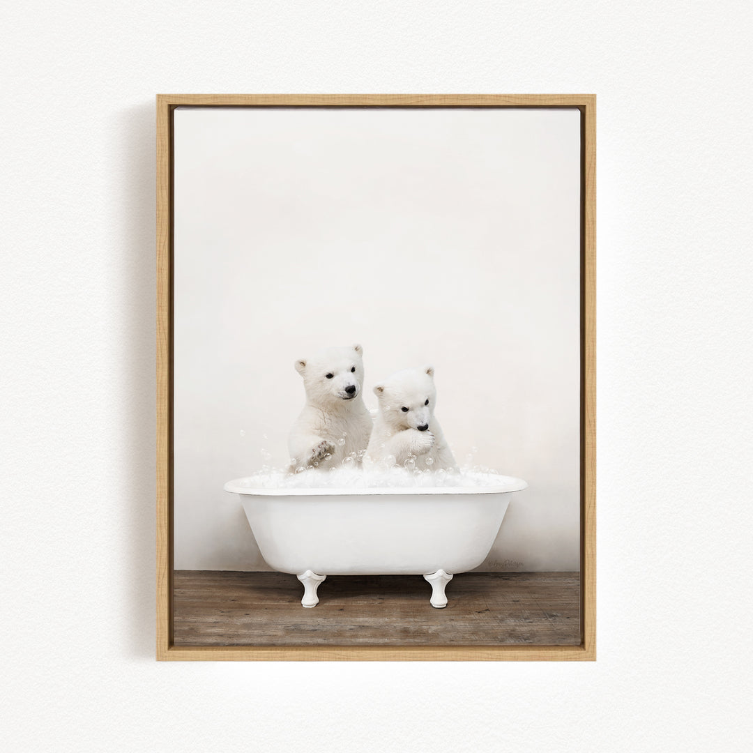 Two adorable polar bear cubs sitting in a white bathtub filled with bubbles, enjoying a playful bath together.