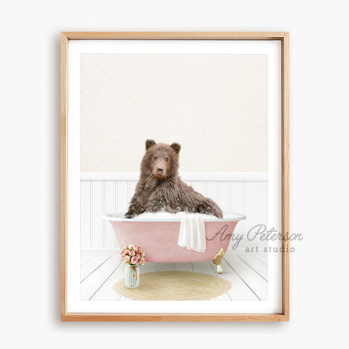 a brown bear sitting in a pink bath tub