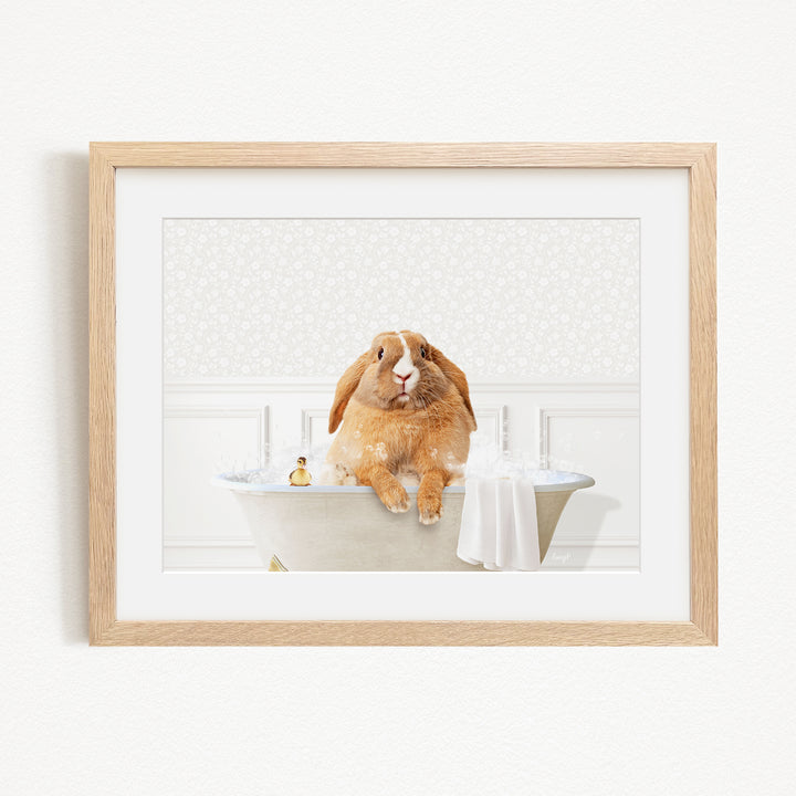 A brown rabbit sitting in a bathtub filled with water, surrounded by a towel and a small toy.