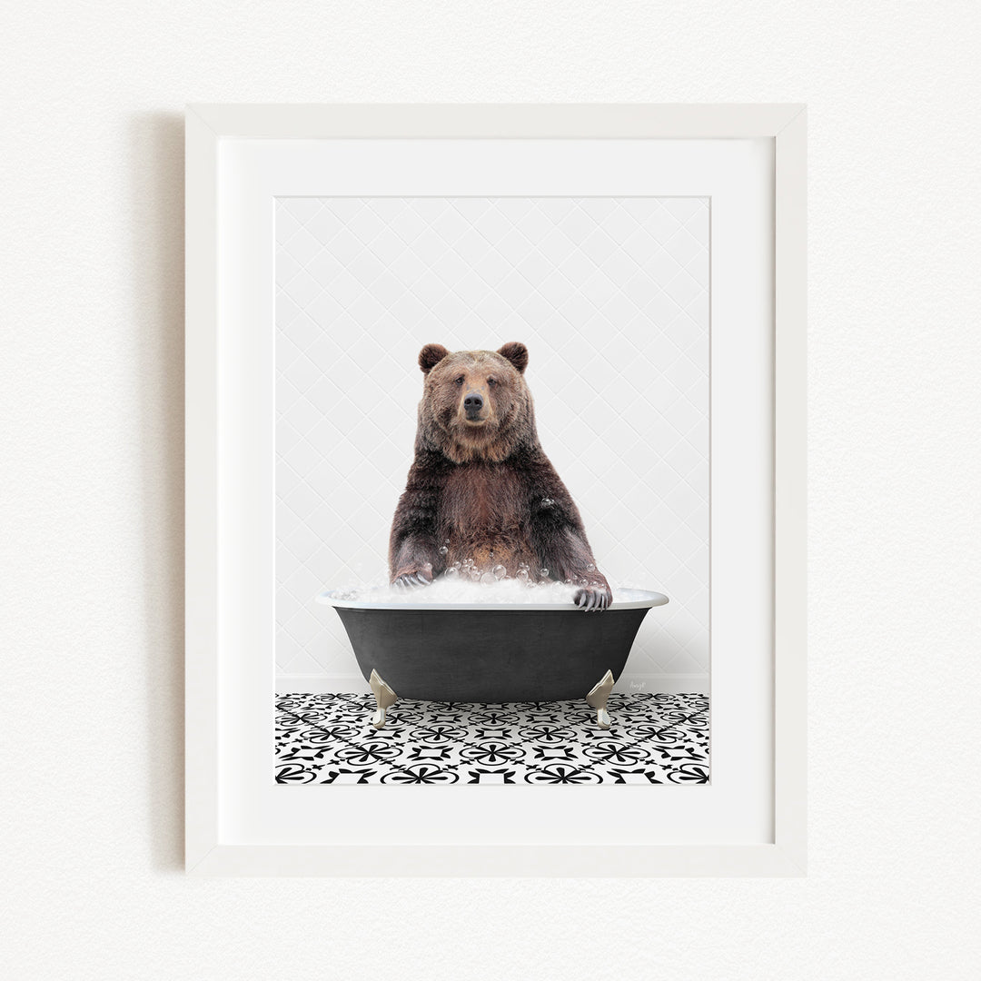 A brown bear sitting in a black bathtub filled with water, surrounded by a black and white patterned floor.
