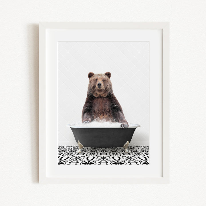 A brown bear sitting in a black bathtub filled with water, surrounded by a black and white patterned floor.