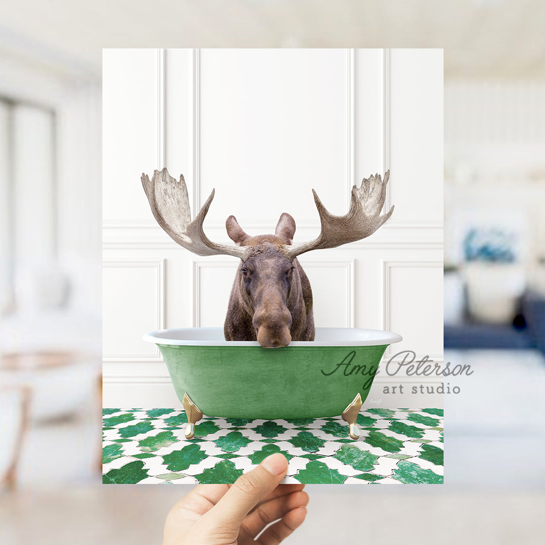 a hand holding a card with a moose in a bathtub