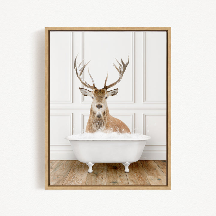 A deer with large antlers is sitting in a white bathtub filled with bubbles, creating a whimsical and unexpected scene.