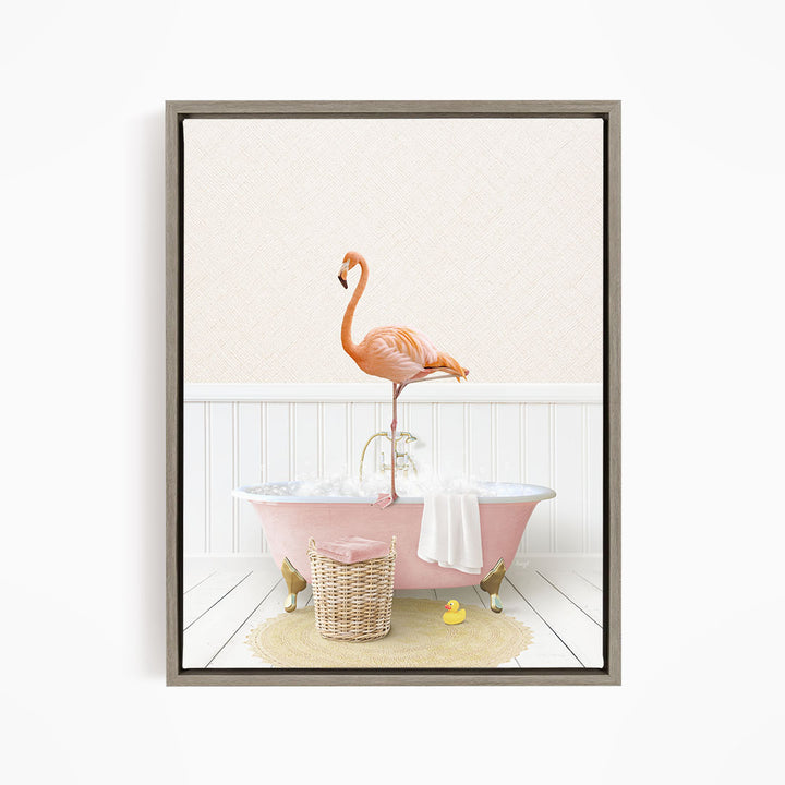 A pink flamingo stands on the edge of a bathtub filled with water, surrounded by a yellow rubber duck and a basket.