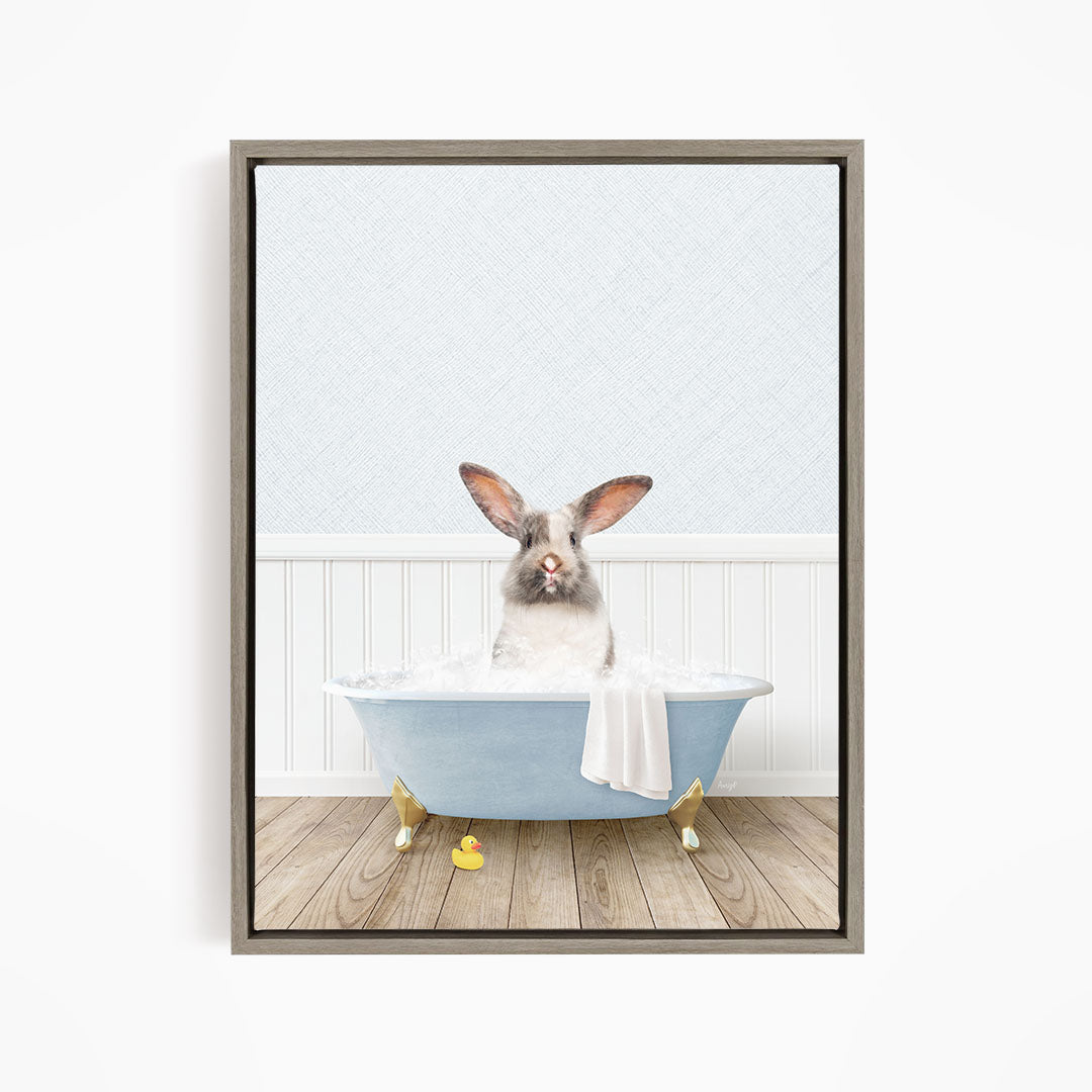 A white rabbit sitting in a blue bathtub filled with water, surrounded by yellow rubber ducks.