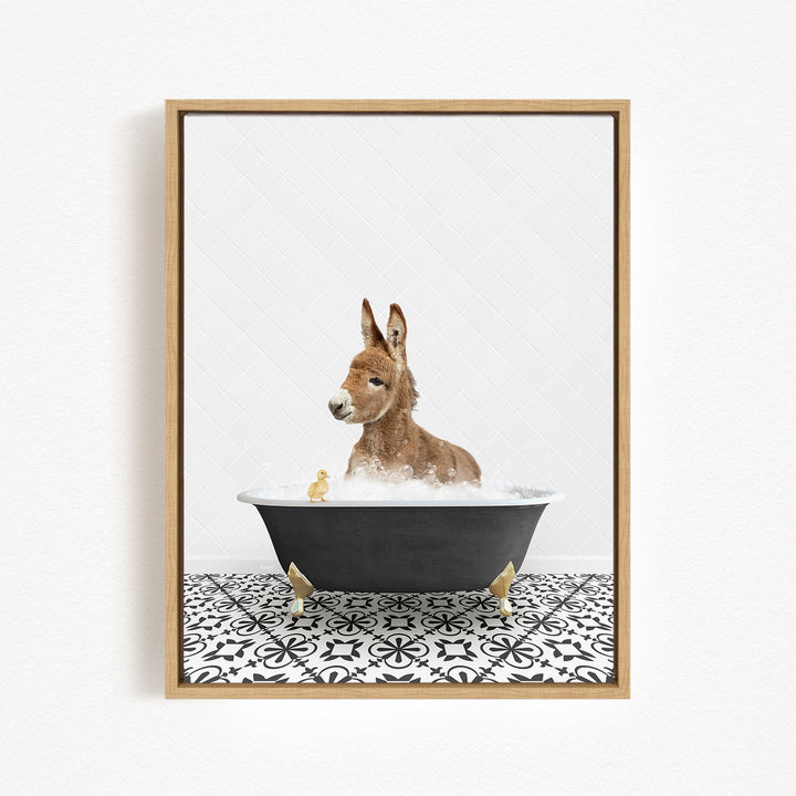 A donkey is sitting in a bathtub filled with water, surrounded by a few small ducks.