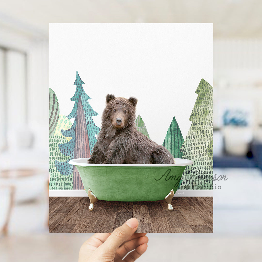 a hand holding a card with a picture of a bear in a bathtub